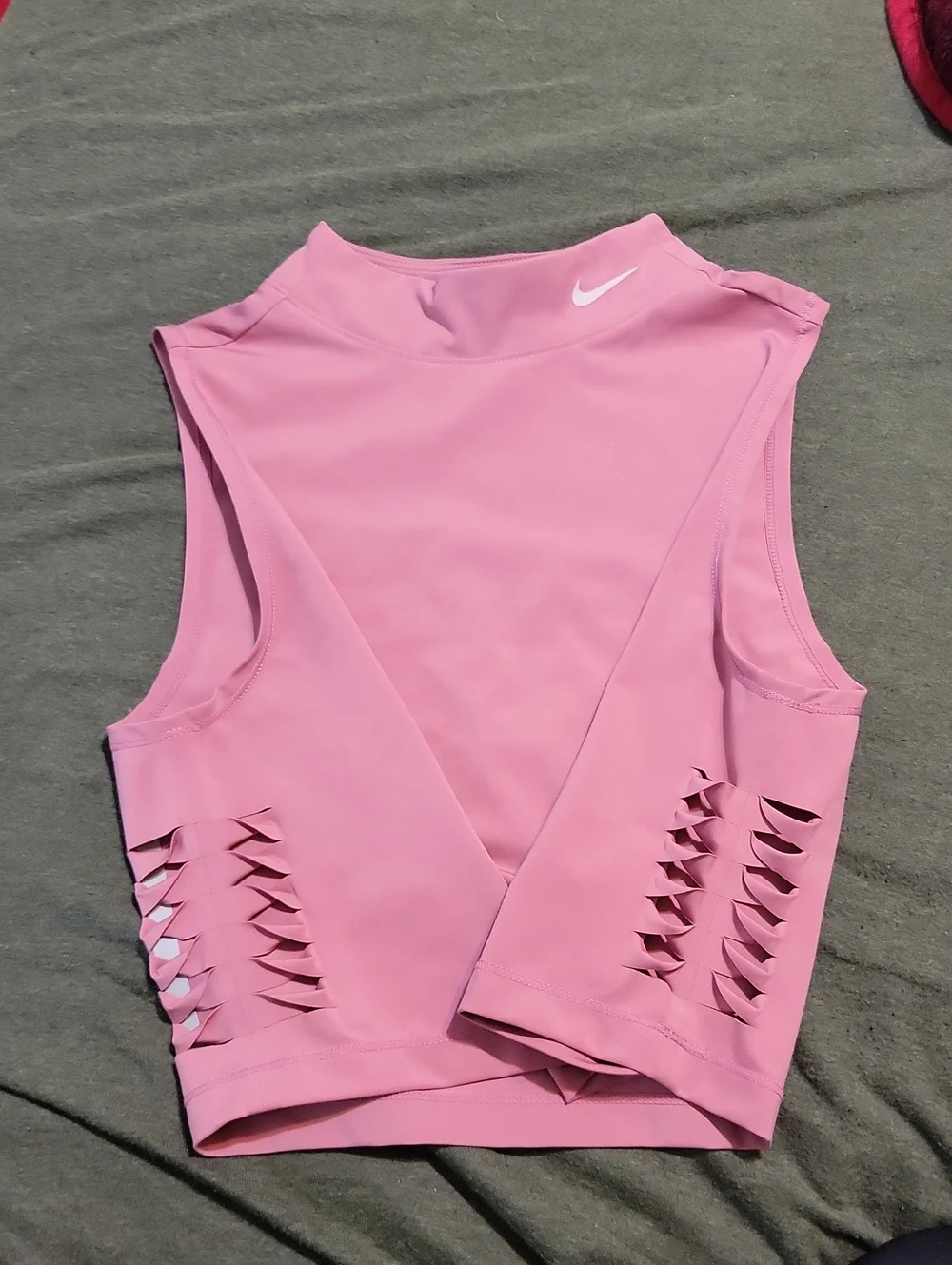 pink Nike Pro Dri-FIT crop top featuring distinctive side-cutout details